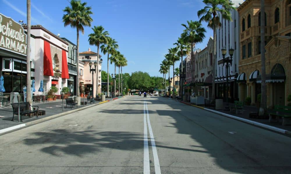 mixed use development street Orlando FL - ALTA SURVEY Orlando alta surveys - A mixed-use urban street in Orlando FL with shops and palm trees, representing development areas surveyed for ALTA use
