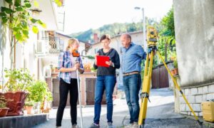 Construction staking survey home property discussion - ALTA SURVEY Orlando Land surveyor discussing property boundaries with homeowners during a construction staking survey