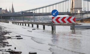 Flooded road under bridge - ALTA SURVEY Orlando Flooded city road under a bridge after heavy rain showing rising water levels linked to flood elevation certificate and insurance claims