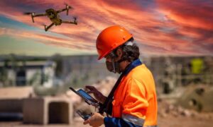 Solar storm construction site - ALTA SURVEY Orlando A surveyor operating a drone on a construction site during a colorful solar storm sky, showing how drone surveying can be affected by GPS disruptions