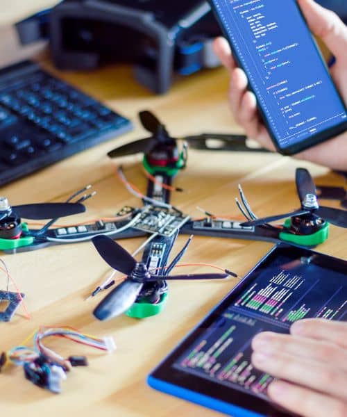 Technician analyzing drone flight data and software used in an unmanned aerial system survey for mapping and construction projects