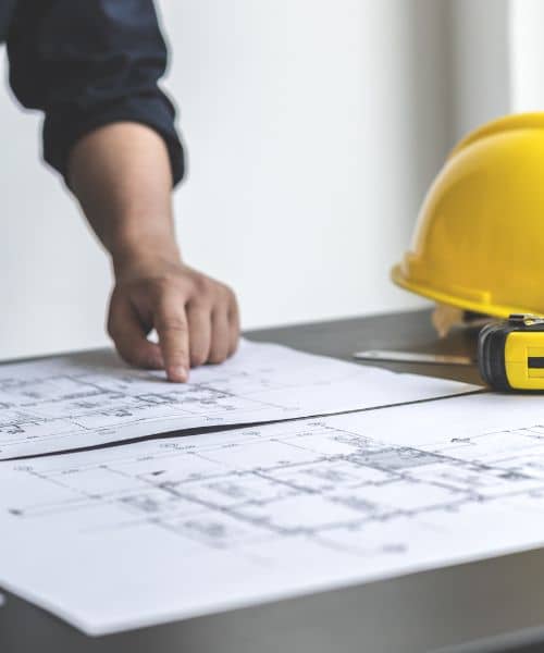 Surveyor reviewing blueprints - ALTA SURVEY Orlando Surveyor reviewing plans and measurements to confirm property lines during a boundary survey