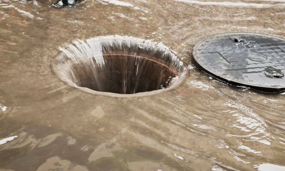Water flowing into a storm drain after heavy rain, showing site changes that may require an updated elevation certificate