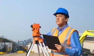 Commercial site surveyor reviewing plans - ALTA SURVEY Orlando Construction survey being reviewed on a commercial development site before project costs are finalized
