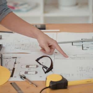 Construction survey details being reviewed on site plans to confirm design assumptions and project costs