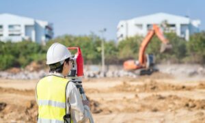 Site layout measurement early construction - ALTA SURVEY Orlando Construction surveyor setting site layout during early construction work