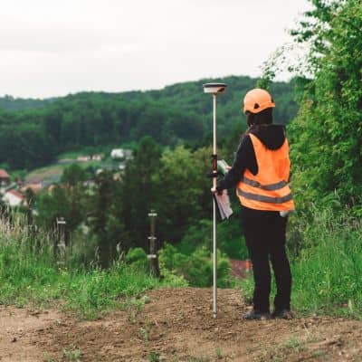 Licensed surveyor near me performing a GPS land survey before construction begins