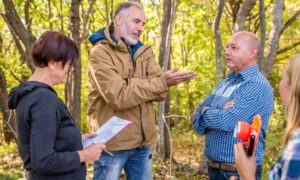 Property boundary discussion - ALTA SURVEY Orlando Surveyor explaining property boundary lines to homeowners during a survey mapping discussion