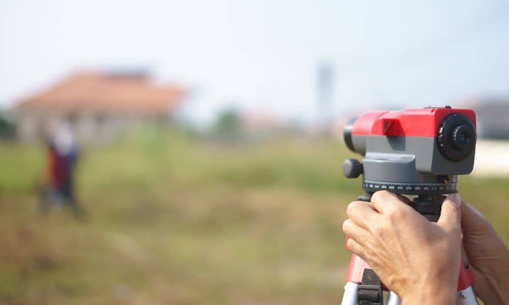 Technician performing a home survey using field equipment on a residential property
