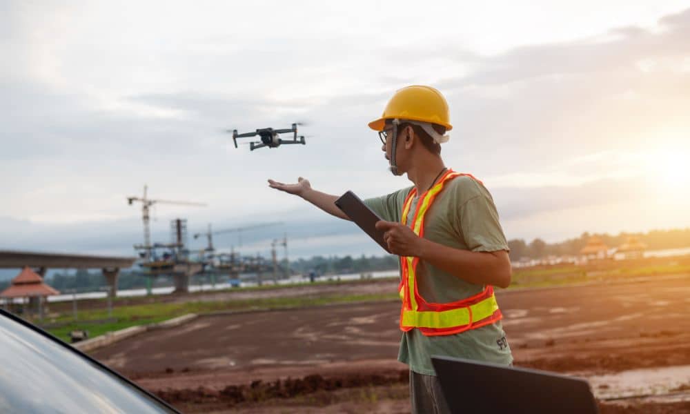 Drone surveying in progress at an active construction site, reflecting how surveying companies use modern technology