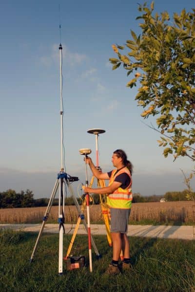 Land surveyor helping find my property line using GPS equipment in the field