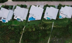 Aerial view of residential homes and pools for a property line survey