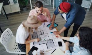Professionals reviewing a property plan while discussing whether an ALTA survey is required for title insurance